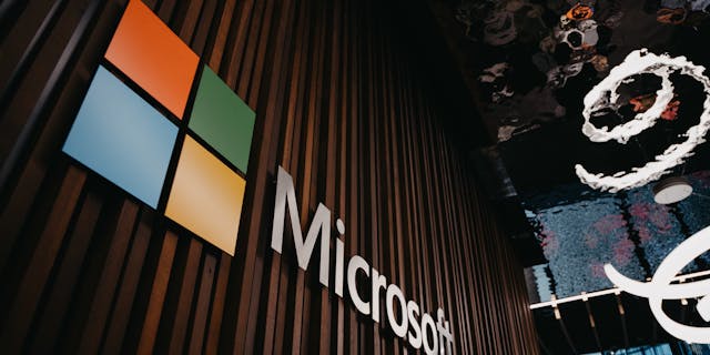 Interior view of Microsoft office with logo on wooden wall in Brussels, Belgium.